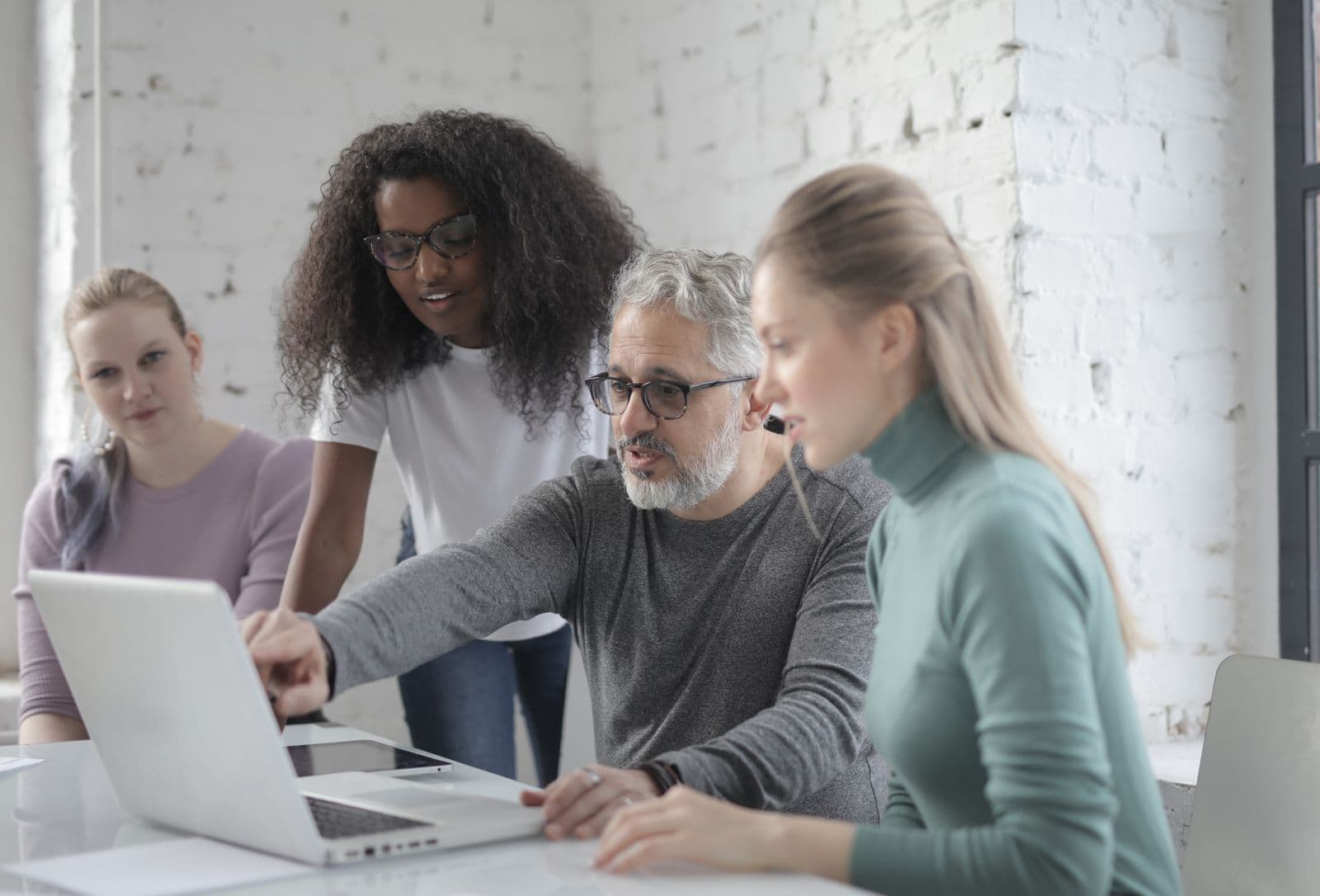 A team looking at a laptop together